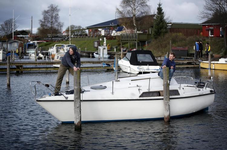 Jacob Bøgh og Daniel Dam Toftegaard er ved at trække deres båd hen til kajpladsen. 
