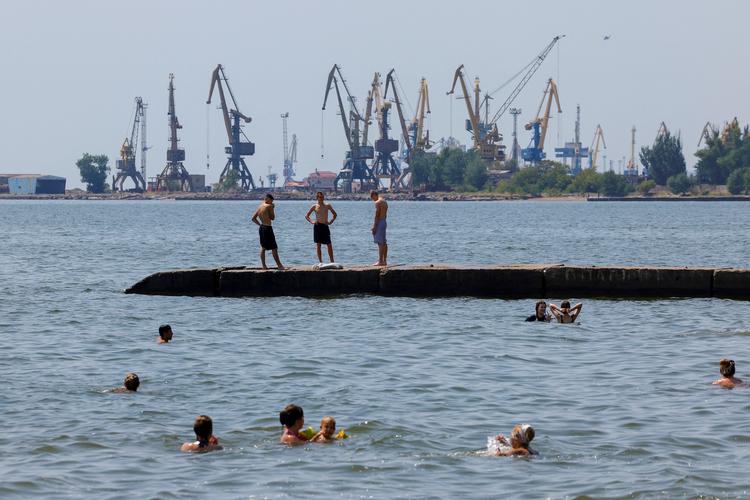 En sommerdag i juli i havnebyen Mariupol ved Det Azovske Hav slapper folk af ved stranden trods krigen i det russisk kontrolerede område. Foto: Alexander Ermochenko/Ritzau Scanpix
