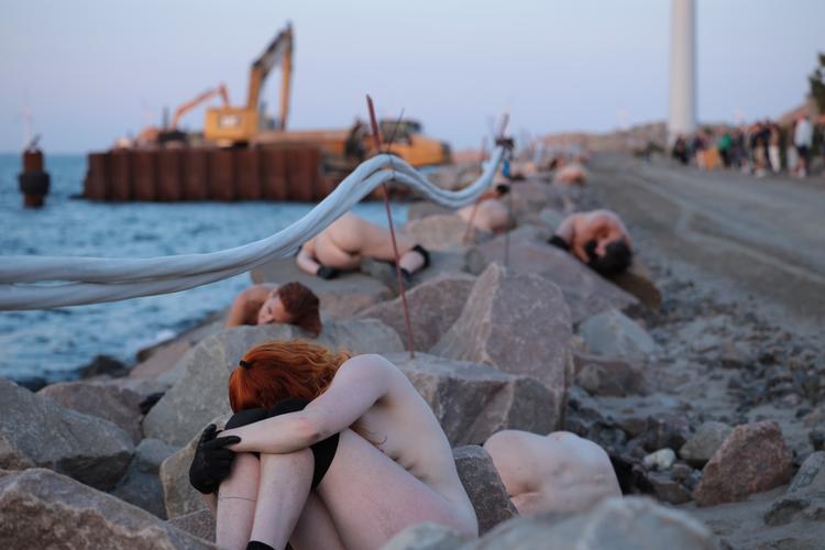 40 nøgne kroppe på jagt efter et bosted. Det går over stok og sten i Refshaleøens hybride landskaber af industri og bynatur.  Foto: Morten Lundrup