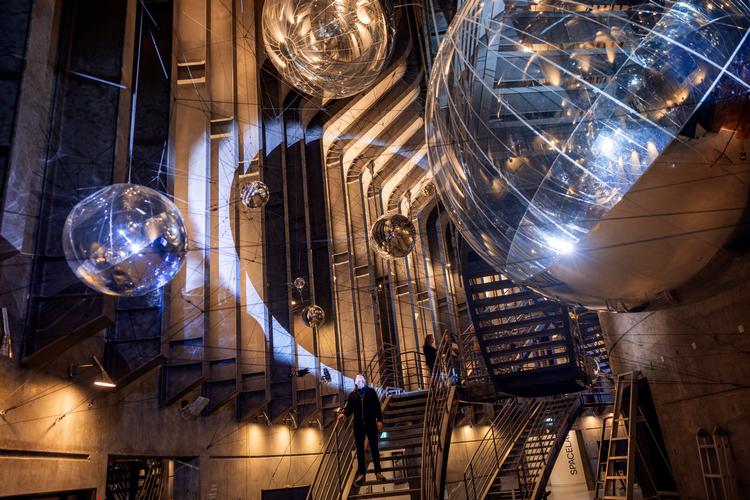 Tomás Saraceno har skabt et univers af kosmiske edderkoppespind og glaskugler inspireret af varmluftballoner i Trappegalleriet på Planetarium midt i København. Foto: Nicolai West