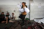 En mand bærer på Al-Ahli hospitalet i Gaza et offer for et israelsk angreb. Foto: Dawoud Abu Alkas/Ritzau Scanpix