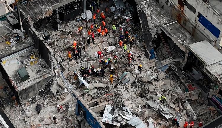 Luftfotoet viser redningsholdet, der arbejder ved natklubben Jet Set  i Santo Domingo, dagen efter taget kollapsede. Redningsfolkene kæmper for at finde overlevende i murbrokkerne. Foto: Alfred Davies/Ritzau Scanpix