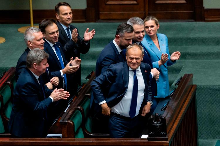 Polens ministerpræsident Donald Tusk smiler og får klapsalver efter at have vundet dagens tillidsafstemning i parlamentet. Men fremtiden lover ikke meget at smile af.  Foto: Wojtek Radwanski/Ritzau Scanpix