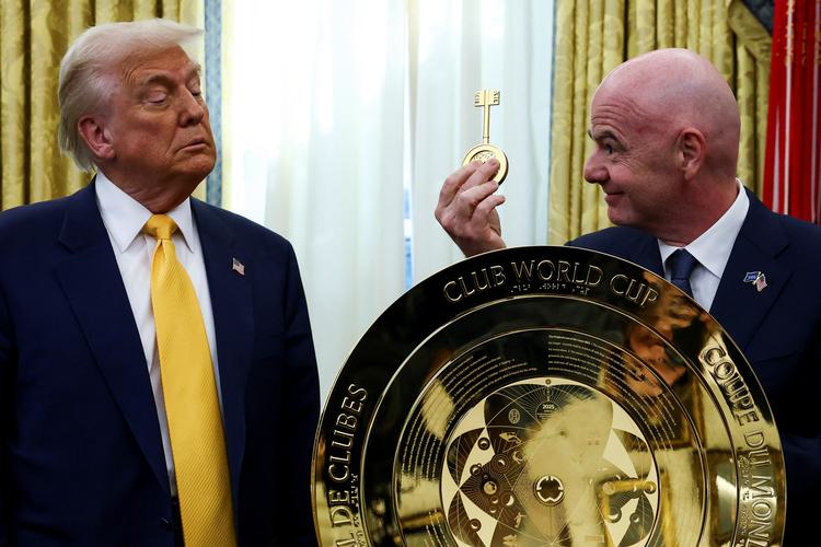   USA’s præsident Donald Trump (tv.) ser ikke videre imponeret ud, da Fifa’s førstemand Gianni Infantino viser ham nøglen til klub-VM-trofæet.  Foto: Evelyn Hockstein/Ritzau Scanpix
