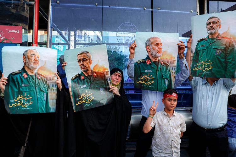 Demonstranter i Teheran holder billeder op af dræbte ledere fra den iranske revolutionsgarde.  Foto: Atta Kenare/Ritzau Scanpix