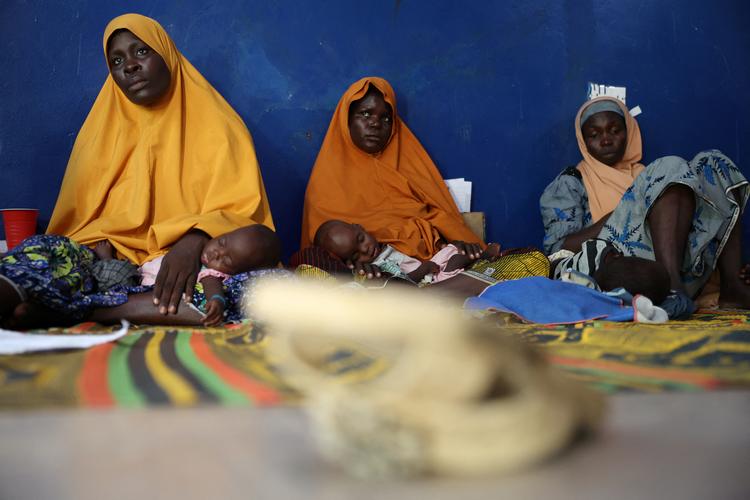 En mor venter sammen med sine børn på at få hjælp ved en sundhedsklinik i Nigeria i august. Udviklingsbistanden til kontinentet er styrtdykket. Foto: Sodiq Adelakun/Ritzau Scanpix