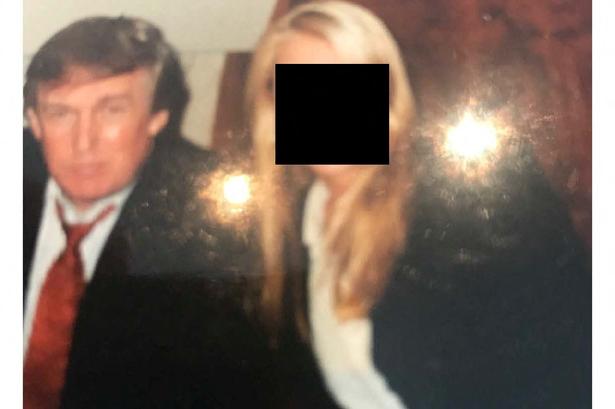 USA's præsident, Donald Trump, ses her i selskab med en anonymiseret kvinde på et billede frigivet af demokraterne i Repræsentanternes Hus' tilsynsudvalg, der står for undersøgelsen af den afdøde sexforbryderen Jeffrey Epstein. Billedet er frigivet af boet efter Epstein. Det er ikke angivet, hvor eller hvornår billedet er taget. Foto: House Oversight Committee Democr/Ritzau Scanpix