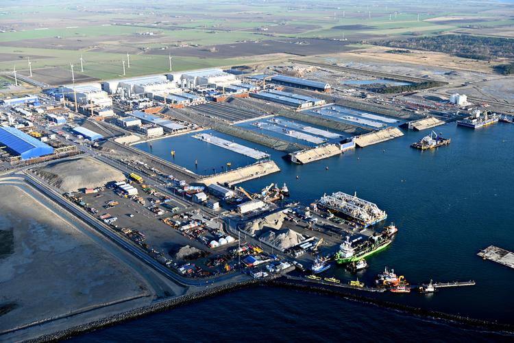 Five tunnel segments are ready at the construction harbor in Rødby (center of the image) to be taken out and lowered to the seabed. Foto: Sund & Bælt / Pr