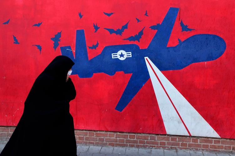 Kan et diplomatisk tiltag fredag forhindre en ny krig mellem Iran og USA? Her går en iransk kvinde forbi et vægmaleri af en amerikansk drone, malet på ydervæggene af den tidligere amerikanske ambassade i Teheran, i daglig tale 'Spionreden'.
 Foto: Atta Kenare/Ritzau Scanpix