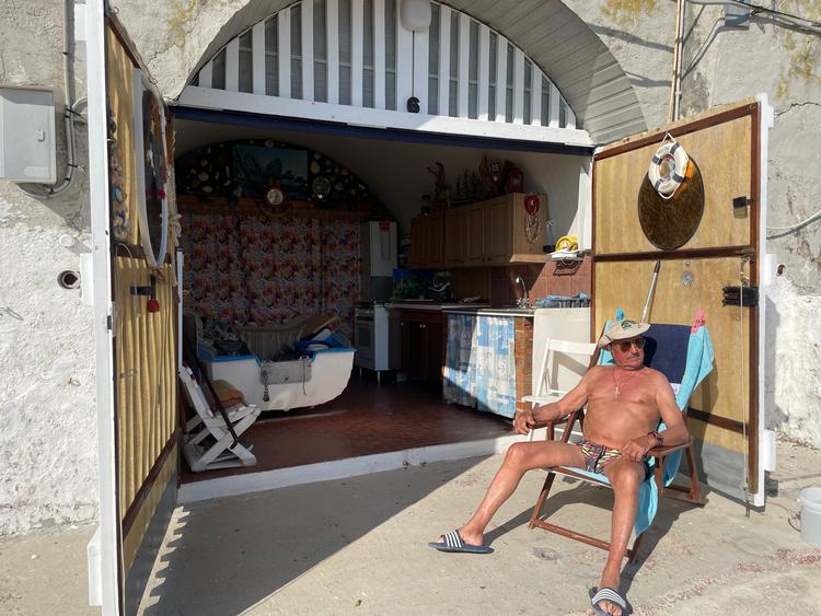 På stranden møder vi en af de ikoniske grottaroli. En ældre herre, der allerede har startet sæsonen i grotten. Han er en af dem, der har udstyret sin grottebolig med køkken, seng, bad og toilet.  