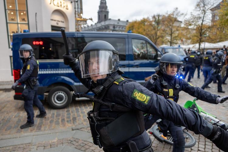 En betjent trækker armen tilbage for at slå Politikens fotograf, Thomas Borberg, med knippel under lørdagens demonstration i København. Thomas Borberg blev slået fire gange og måtte efterfølgende på skadestuen. Foto: Thomas Borberg