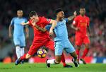 Liverpool's James Milner, (tv) tackler Manchester City's Raheem Sterling. 