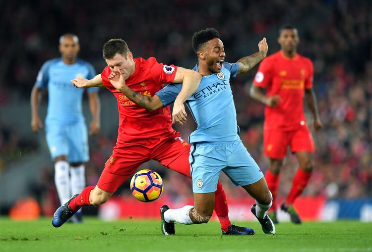 Liverpool's James Milner, (tv) tackler Manchester City's Raheem Sterling. 