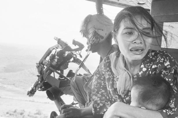 To vietnamesiske flygtninge reddes af en amerikansk helikopter. 22. marts 1975. 