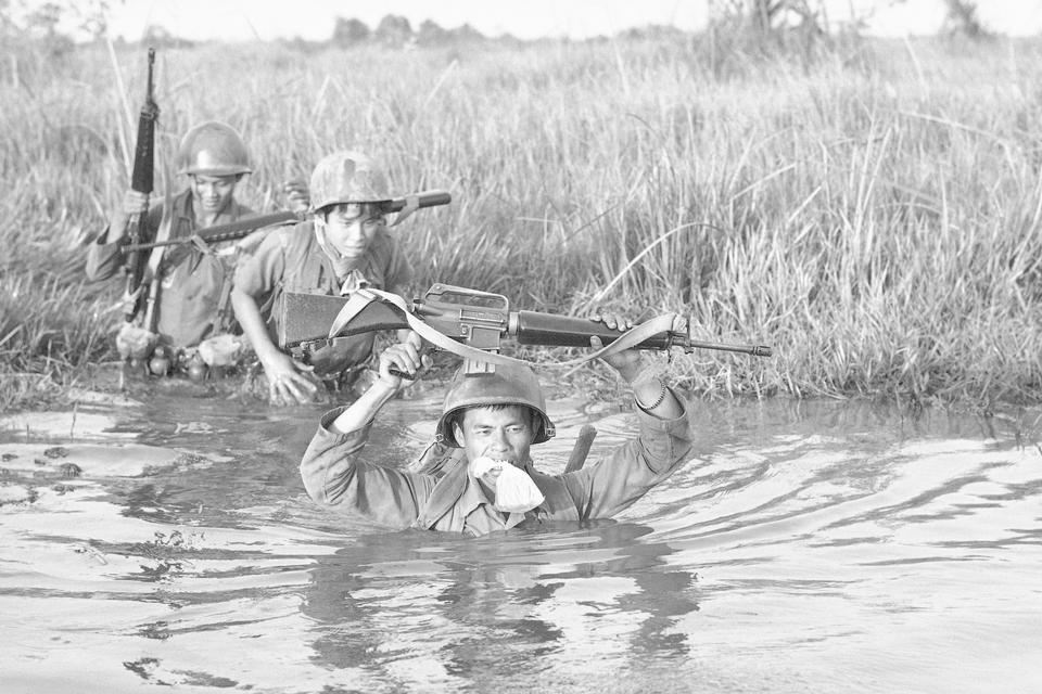 Tre sydvietnamesiske soldater krydser en kanal. 11. marts, 1972.  