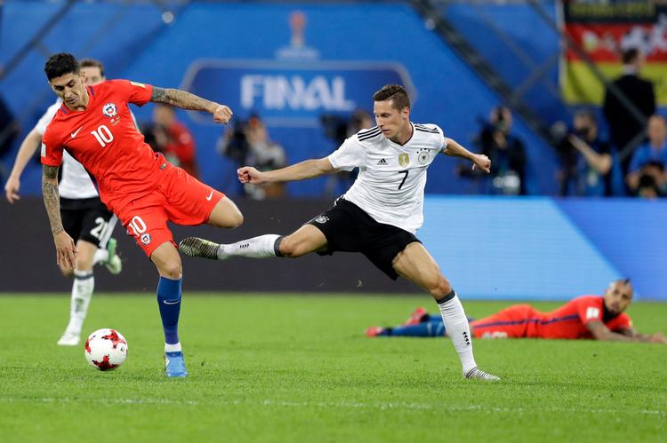 Tysklands anfører Julian Draxler i nærkamp med Chiles Pablo Hernandez. 