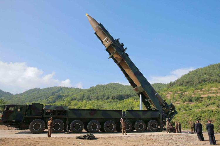 Nordkoreas leder, Kim Jong Ung (nr. 2 fra højre) inspicerer missilet, inden det blev affyret.  