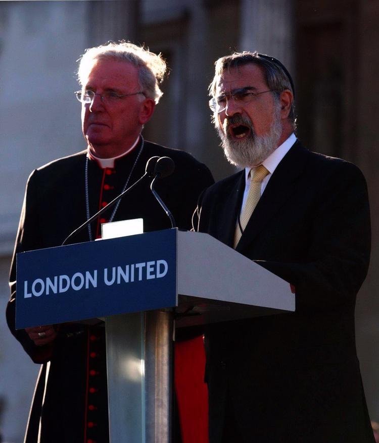 Jonathan Sacks (til højre) taler til Londons befolking efter terrorangrebet i 2005, hvor fire bomber sprængtes i offentlige transportmidler. Ved siden af ham ses den daværende ærkebiskop af Westminster, kardinal Cormac Murphy-O'Connor.  