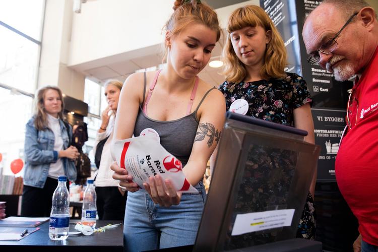 
    Red Barnet havde fået lov at etablere et indsamlingssted hos Arnold Busck Boghandel i Købmagergade. Emma Schasching og Mathilde Lerhøj i baggrunden venter på deres indsamlingsresultat. 501,50 kr.  
