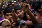 Myanmars minoritetsflygtninge rækker ud efter mad. 