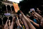 Massevis af studenter besatte fredag en af Barcelonas største universiteter, mens de symbolsk rakte deres hånd op i vejret og råbte slogans for selvstændighedsafstemningen. Foto: Emilio Morenatti