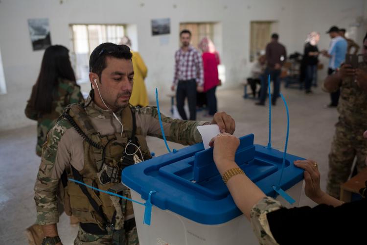 En kurdisk sikkerhedsvagt stemmer til uafhængighedsafstemningen i Irak. 
