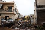 
    A man, top right, looks out from his home over piles of vehicles in the municipality of Madra western Athens, on Wednesday, Nov. 15, 2017. Flash floods in the Greek capital's western outskirts Wednesday turned roads into raging torrents of mud and debris, killing at least nine people, inundating homes and businesses and knocking out a section of a highway. (AP Photo/Petros Giannakouris)
   