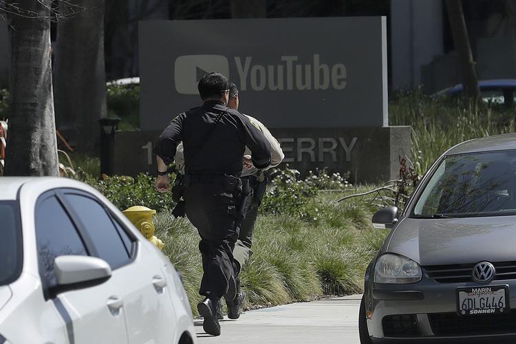 Politibetjente løber mod Youtubes hovedkvarter i San Bruno i Californien. Jeff Chiu/AP