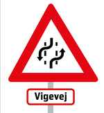 Vinderskiltet er en advarselstrekant med stiplede linjer og pile, der indikerer kørslen, samt en omdøbning af 2 minus 1-vej til vigevej. Grafik: Mads Pedersen 