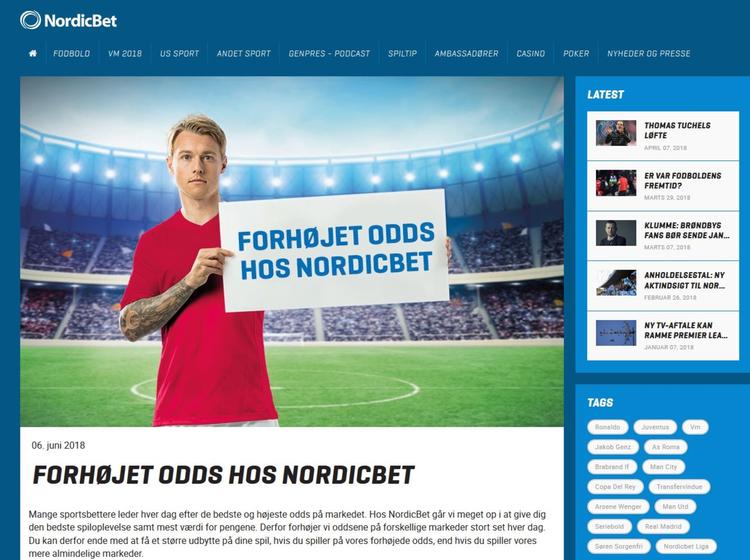 Simon Kjær poserer i rødt og hvidt i denne reklame for spilselskabet NordicBet - men det er over stregen, mener DBU. Screenshot fra nordicbet.dk
   Skærmbillede