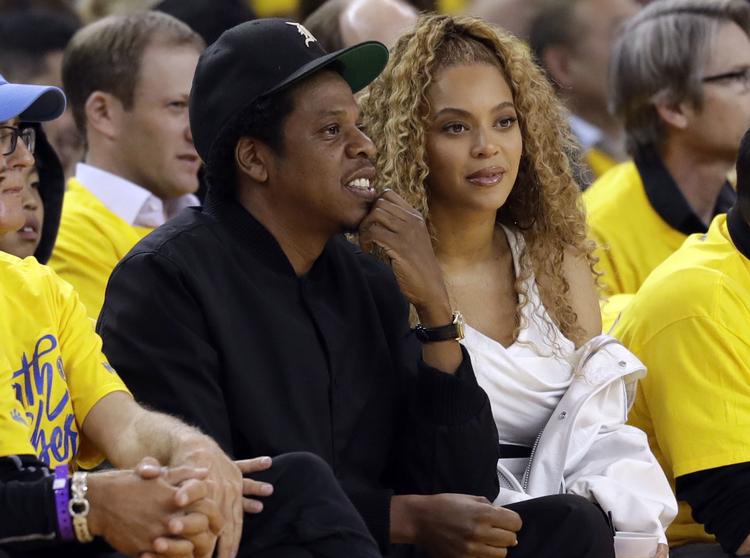 Jay-Z and Beyonce ser her en basketball-kamp sammen. De har også haft travlt med at producere et album.  Marcio Jose Sanchez/AP