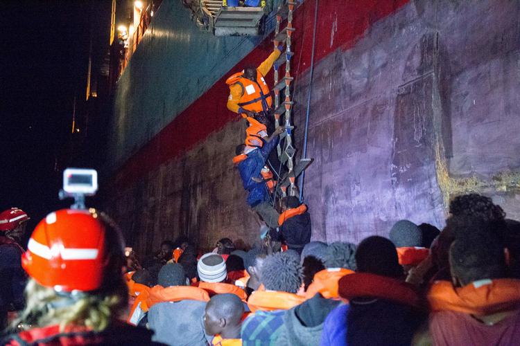 Besætningen på containerskibet 'Alexander Maersk' samler her nødstedte migranter op. Billedet er taget af det tyske NGO-'Mission Lifeline'.  Danilo Campailla/Ritzau Scanpix
