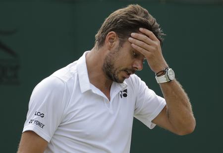 Wimbledon er den eneste grandslam-turnering     Stan Wawrinka mangler at vinde, men den knæopererede schweizer er ude af dette års turnering. Ben Curtis/AP