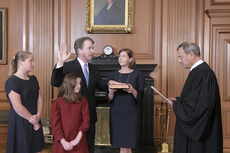 Højesteretspræsident,  John Roberts, (th), tager Brett Kavanaugh i ed. Ashley Kavanaugh, Brett Kavanaughs hustru, holder biblen, mens døtrene Margaret (venstre) og Liza ser til. Fred Schilling/AP