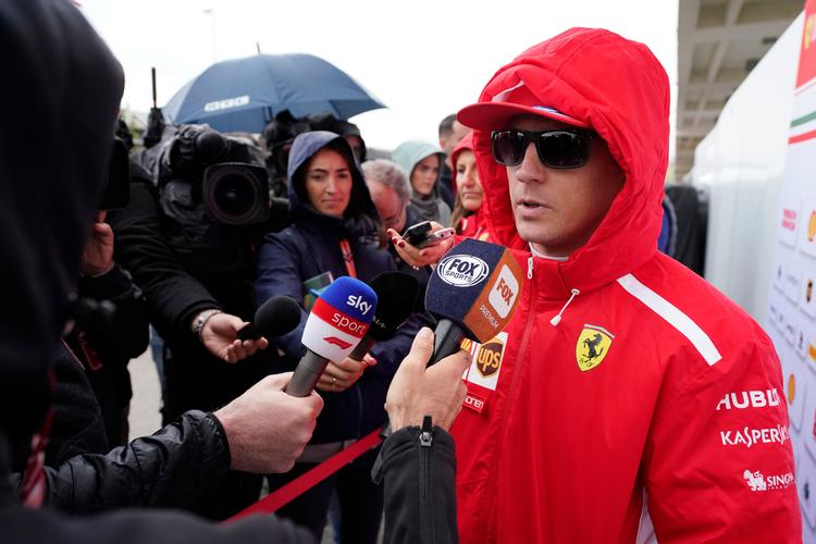 Kimi Räikkönen i gang  noget af det, han hader allermest: at tale med journalister. Ofte er han som her formummet bag store solbriller. Darren Abate/AP