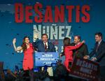 Den nyvalgte republikanske guvernør Ron DeSantis i midten, vinker til sine støtter med sin hustru på sin venstre side. Chris Urso/AP
