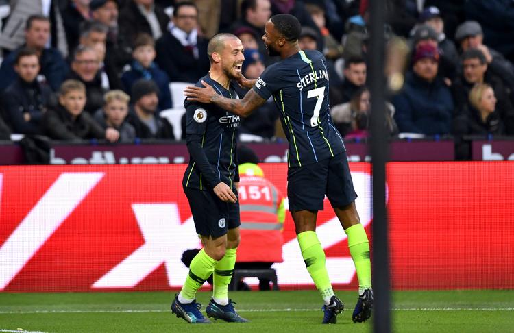 David Silva og Raheem Sterling jubler i London, hvor Manchester City-profilerne igen skaffede en sejr i Premier League. Foto: Dominic Lipinski/AP