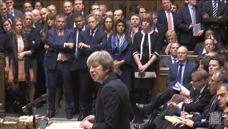 Theresa May i det britiske parlament i går, hvor hun forklarede og forsvarede sin beslutning om at udskyde afstemningen om hendes brexitaftale med EU. Foto: Parbul/AP