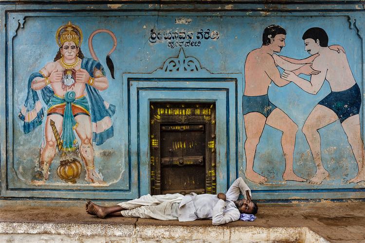 Badami, Indien. Ved indgangen til et træningslokale for de lokale brydere, tager en mand sig et hurtigt hvil. Foto: Stefano Pensotti/Travel Photographer of the Year