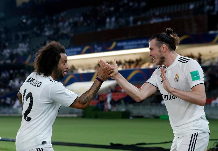 Gareth Bale fejrer en af sine tre scoringer med holdkammeraten Marcelo. Foto: Hassan Ammar/AP