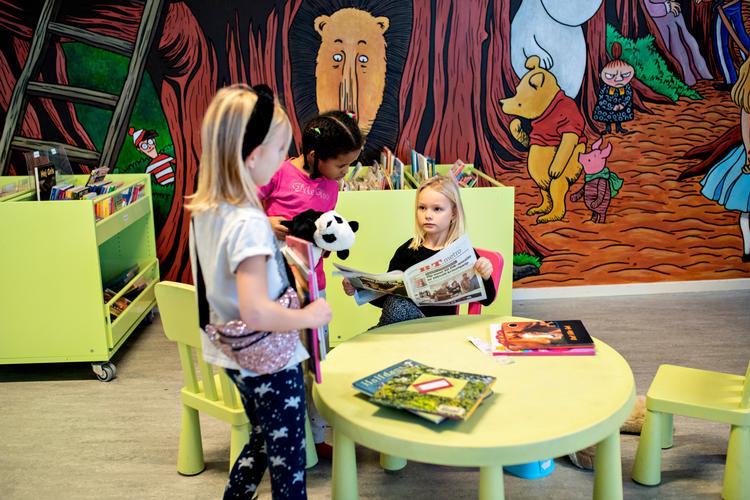 
En af stamgrupperne har time på biblioteket, og mens de andre elever leder efter bøger, kigger Mille (6 år) i avisen. Sigrid (6 år) og Amira (6 år) vil gerne vide hvad Mille læser.


   Foto: Maud Lervik/POLFOTO