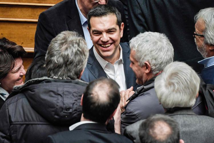 En glad Alexis Tsipras bliver lykønsket, efter at han har vundet mistillidsafstemningen.  Foto: Louisa Gouliamaki/Ritzau Scanpix