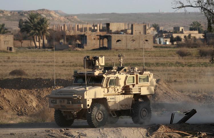 Et amerikansk militærkøretøj kører gennem en syrisk landsbyi den østlige provins Deir Ezzor for et par uger siden.   Foto: Delil Souleiman/Ritzau Scanpix