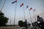 Kinas og Nordkoreas flag vejer side om side på Kim Il Sung Plads i Pyongyang. Kinas præsident, Xi Jinping, ankom i dag til landet for at mødes med Kim Jong-un. Besøget er det første fra en kiinesisk leder besøger landet i 14 år.  Foto: Ed Jones/Ritzau Scanpix