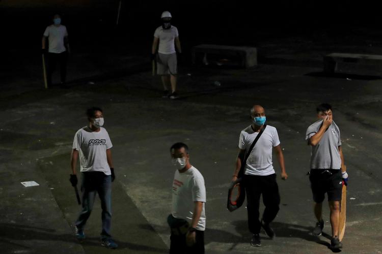 Mænd klædt i hvide t-shirts angreb natten til mandag demonstranter i Hongkong med køller. Foto: Tyrone Siu/Ritzau Scanpix