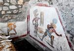 Et opsigtsvækkende kalkmaleri i et udgavet bordel i Pompeji viser en kamp mellem to gladiatorer, hvor den ene er stærkt såret og bløder fra håndleddet og brystkassen. Foto: Handout/Ritzau Scanpix
