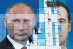 Arbejdere i færd med at sætte en stor plakat op af Putin og Medvedev. Sidstnævnte har trukket sig som regeringsleder som konsekvens af Putins planer om at ændre forfatningen. Foto: Eduard Korniyenko/Ritzau Scanpix
