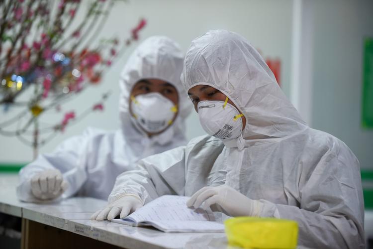 Sundhedspersonale på 
National Hospital of Tropical Diseases i Hanoi, Vietnam, behandler tre personer, der er smittet med coronavirus.  Foto: Nhac Nguyen/Ritzau Scanpix