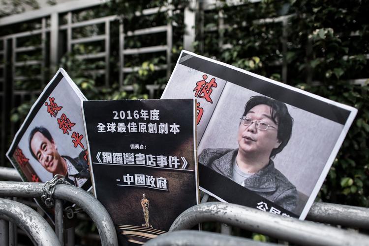 Demonstranter i Hongkong kræver ved en tidligere demonstration Gui Minhai løsladt. Hans billede ses på plakaten til højre. Foto: Philippe Lopez/Ritzau Scanpix