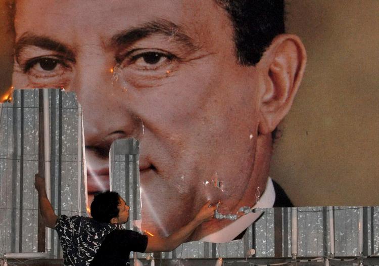 Her flår en egyptisk demonstrant en plakat af Hosni Mubarak ned under det arabiske forår i 2011.      Foto: Stringer Egypt/Ritzau Scanpix